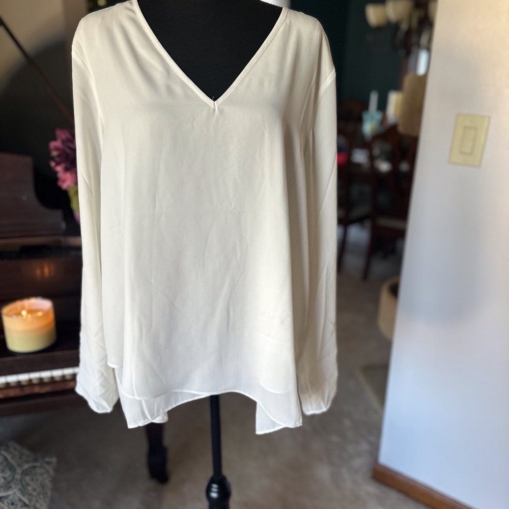 Cream colored soft blouse.